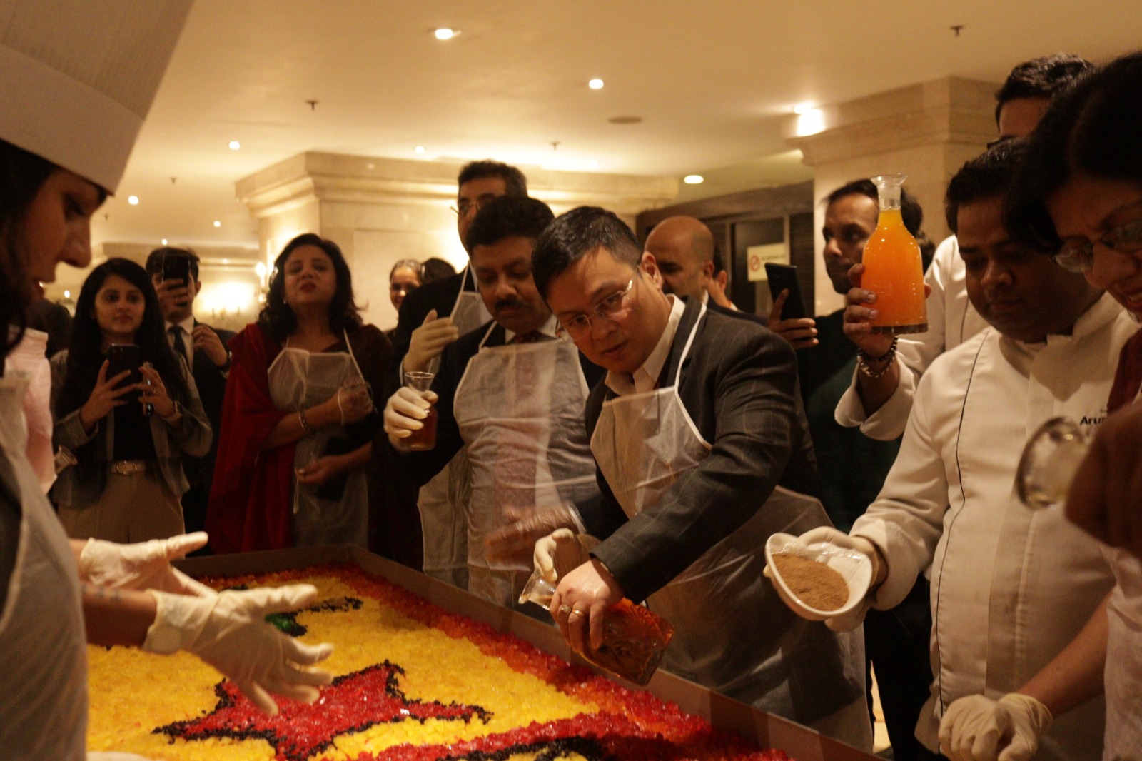 Chefs at Ashok Hotel join hands with home bakers for the Christmas cake mixing